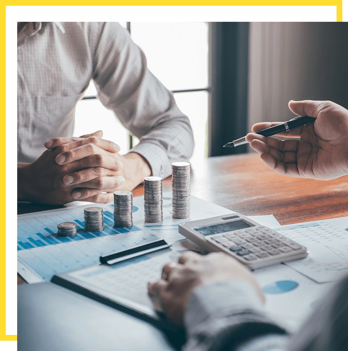 Hands gesturing over financial documents